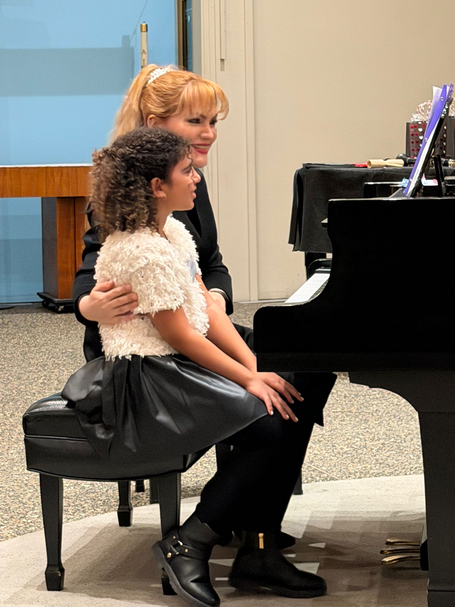 Student and teacher at piano together