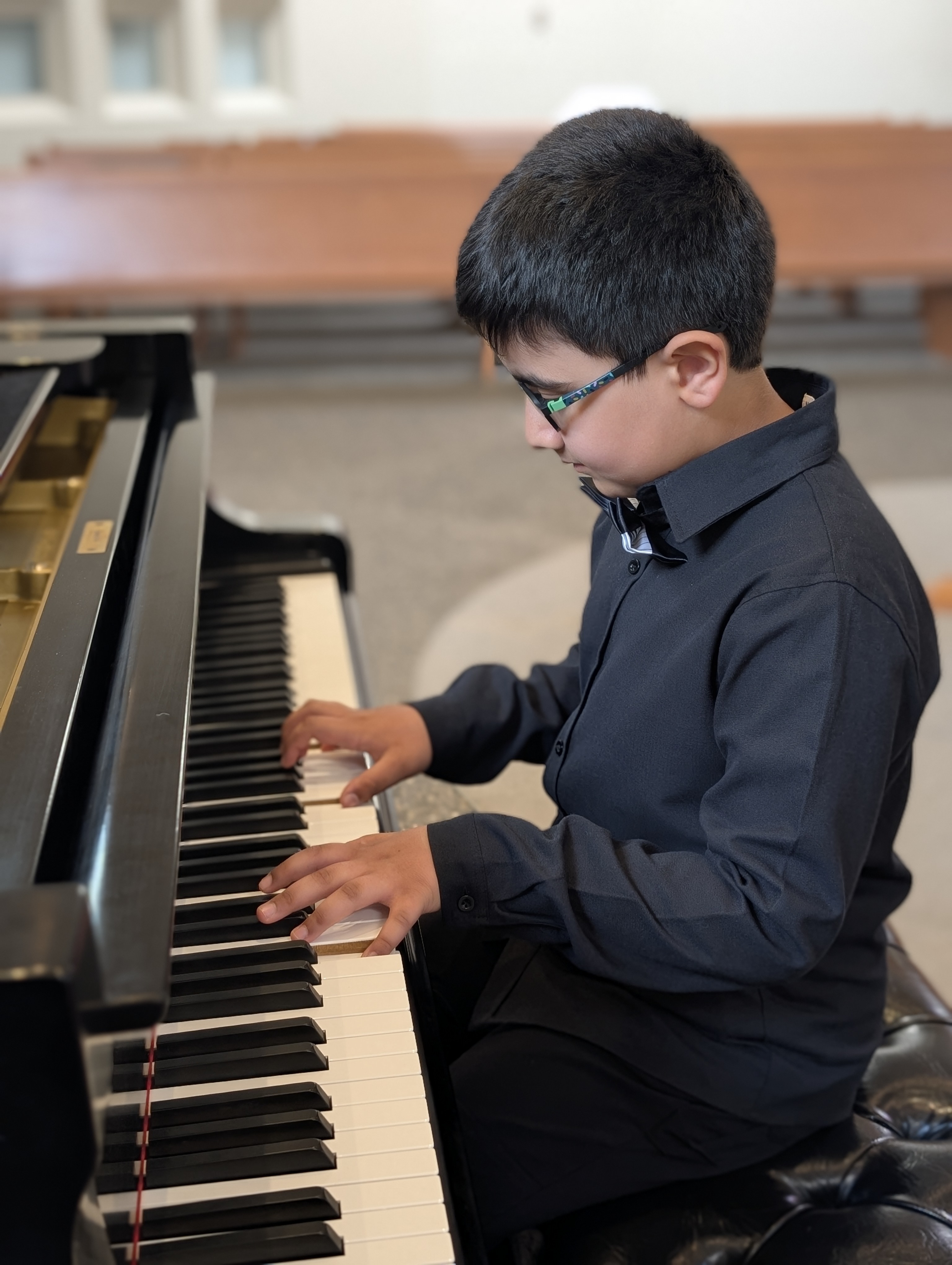 Young student focused at piano